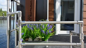 A metal railing with a planter of lavender plants.