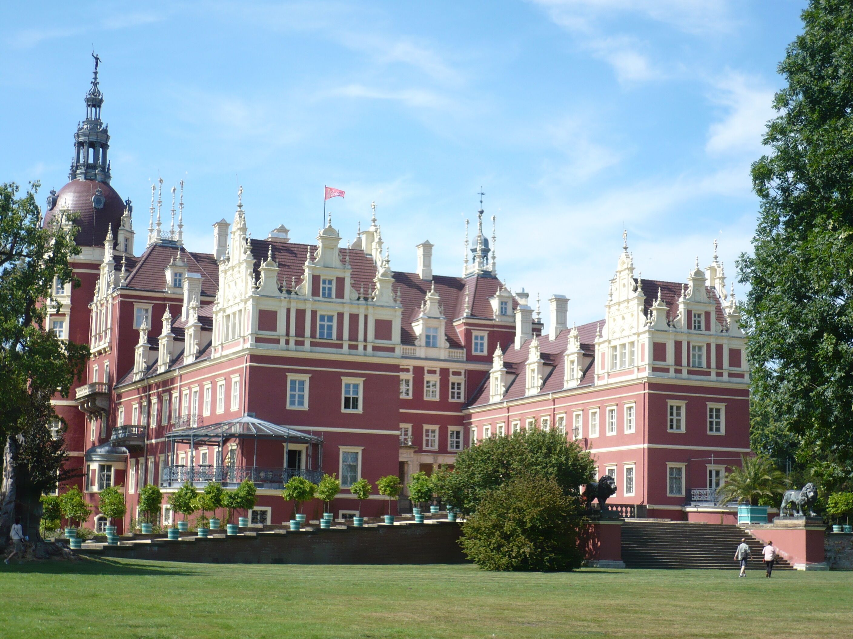 A large, historic building with multiple towers and a prominent dome.