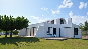 A modern, single-story house with a flat roof and large windows. - A private,family-friendly estate with pool, garden,and all comforts—near the sea (Faros Avlidas)