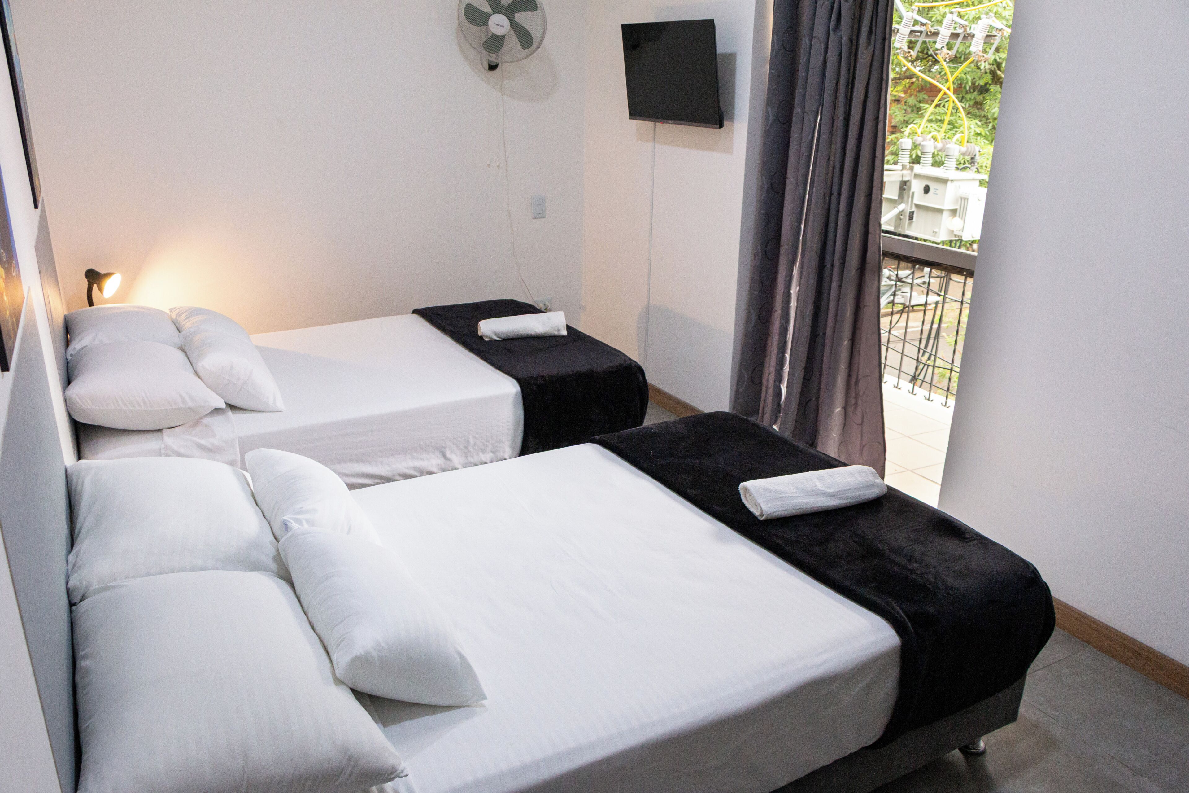 Standard Quadruple Room | Minibar, desk, laptop workspace, blackout drapes