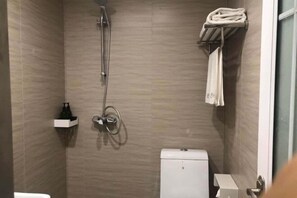 A small, modern bathroom with a shower, toilet, and a towel rack. - yun jing Hotel (Shanghai Songjiang University Town) (Shanghai)