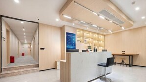 A reception desk with a counter, a chair, and a small table with stools. - yun jing Hotel (Shanghai Songjiang University Town) (Shanghai)