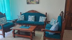 A living room with a sofa set, two armchairs, and a coffee table. - TERRAZAS BY YALP (Santa Maria Huatulco)
