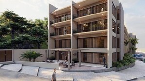 A multi-story building with balconies, outdoor seating, and a landscaped area. - COSTTA BY YALP (Santa Maria Huatulco)