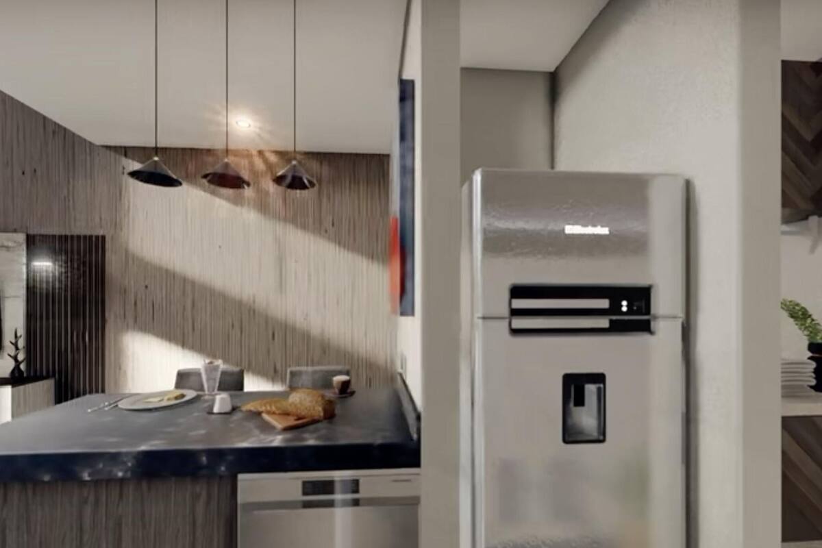 A modern kitchen with a built-in refrigerator, a dining area with a marble countertop, and pendant lighting.