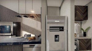 A modern kitchen with a built-in refrigerator, a flat-screen TV, and a wooden accent wall. - COSTTA BY YALP (Santa Maria Huatulco)
