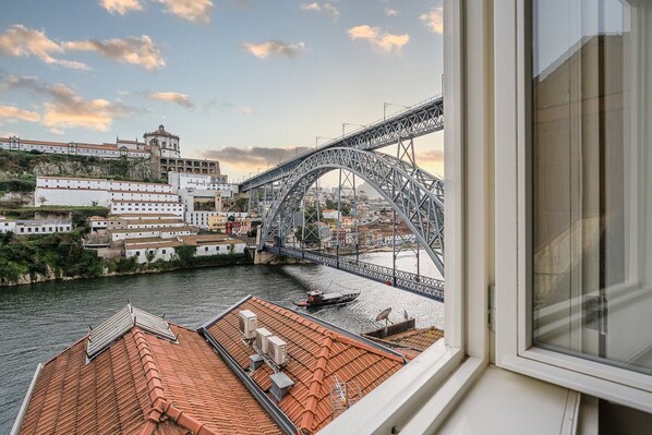 A view of a bridge over a river with buildings on the opposite bank.