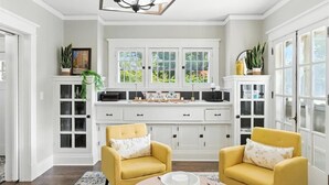A bright, well-lit room with a large window, a chandelier, and two yellow armchairs. - Your Summer HQ!  Ditch the Hotel Rooms! Sleeps 11.   Pet-Friendly! (Dayton)