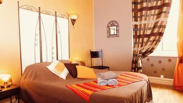 Relax in comfort with a large bed, bedside table, and wall-mounted mirror.
