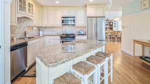 A spacious kitchen with a large island, built-in appliances, and a high ceiling with skylight. - Ocean View Cape May Beach Home w/ Deck | Sleeps 14 (Cape May)