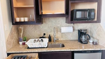 Fridge, microwave, coffee/tea maker, cookware/dishes/utensils