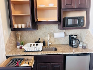 Fridge, microwave, coffee/tea maker, cookware/dishes/utensils