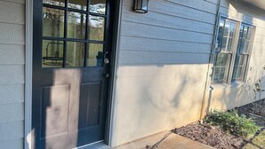 A house with a dark front door, a small porch, and a window with a white frame. - Private, huge walk-out basement, great location (Marietta)
