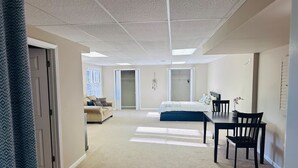 A spacious room with a large bed, a dining table with chairs, and a sofa. - Private, huge walk-out basement, great location (Marietta)
