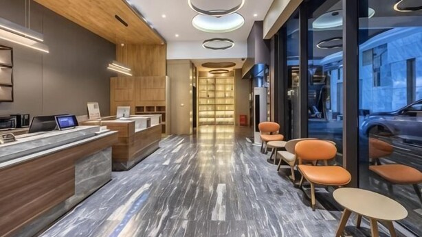 A modern hotel lobby with a reception desk, seating area, and large windows. - Lishe International Apartment (Shanghai Huaihai Middle Road) (Shanghai)
