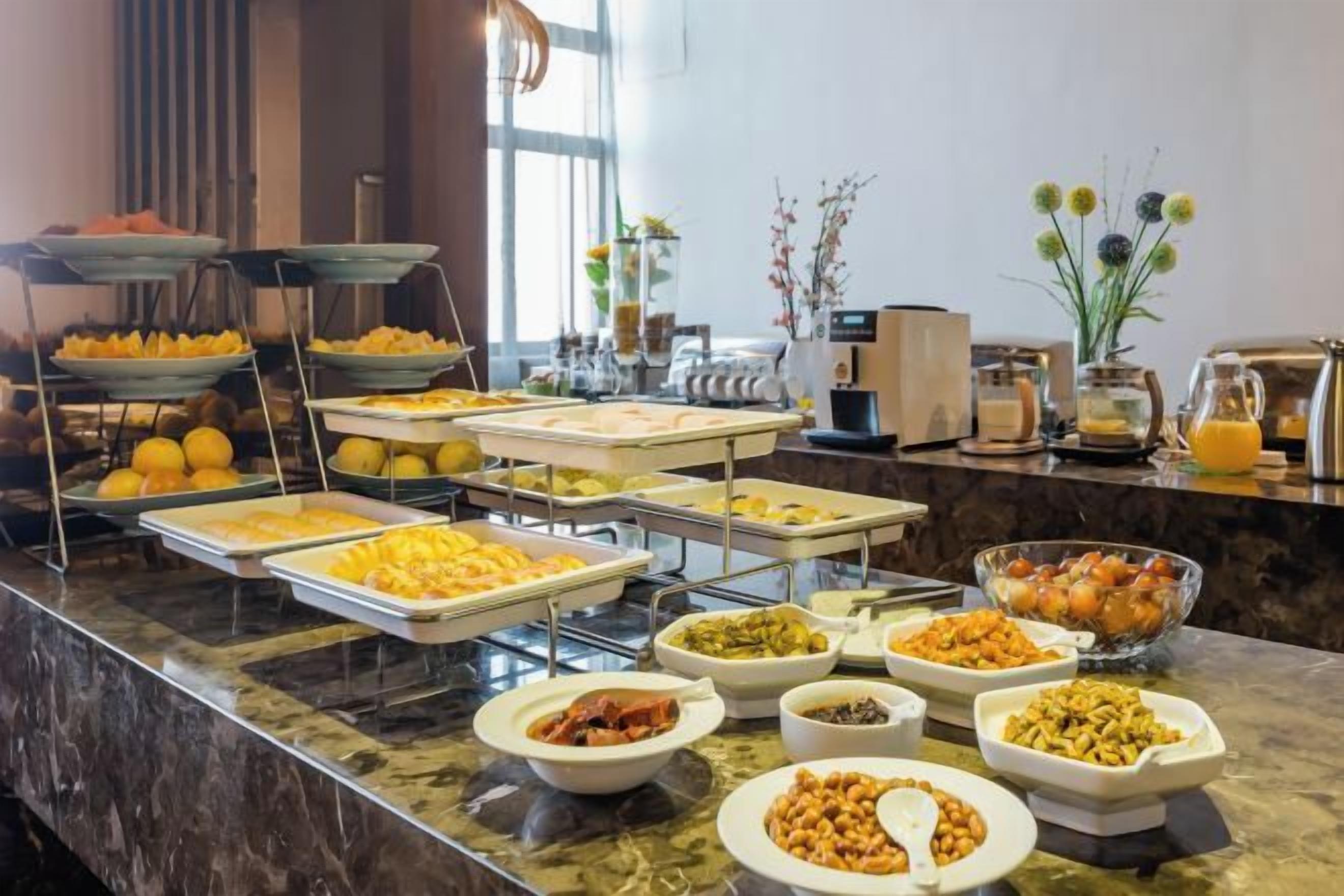 A buffet with various food items and a coffee station.
