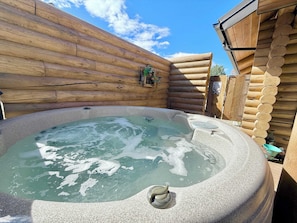 Relax in a hot tub surrounded by the rustic charm of this cabin.