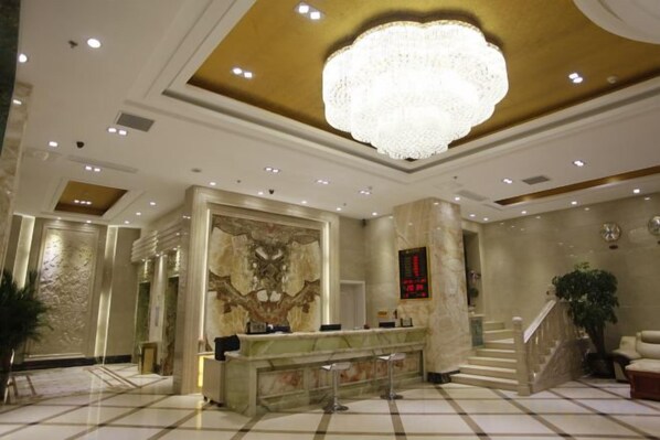 A hotel lobby with a reception desk, a grand chandelier, marble flooring, and a staircase. - Zhaoyuan Wenfeng Hotel (Zhaoyuan)