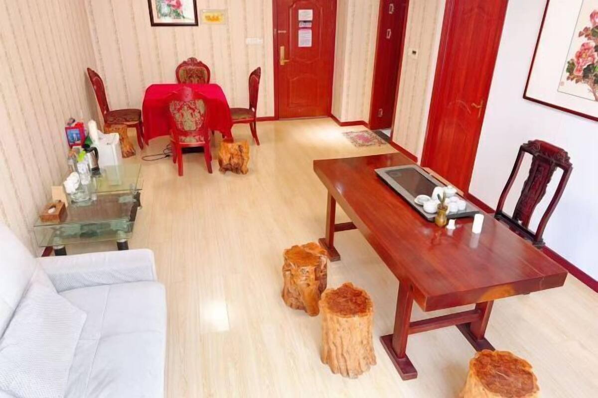 Una habitación con una mesa de comedor, sillas, un sofá y una mesita de vidrio.