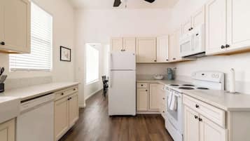 Enjoy cooking in this well-equipped kitchen with a refrigerator, microwave, and stove.
