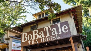A building with a sign that reads "BoBaTale Tea House."