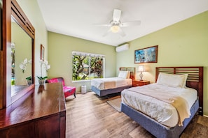 Relax in this inviting room with a large bed, a smaller bed, and a cozy seating area.