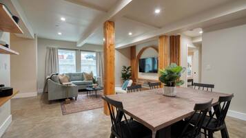 Dining area with kitchen and sofa nearby.