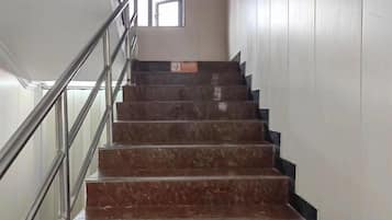 A staircase with metal railings and a window at the top.