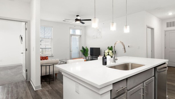 A modern kitchen with a large island, stainless steel appliances, and pendant lighting. - Stylish Stay | Near Everything! (Whitestown)