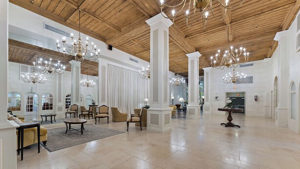 A spacious lobby with high ceilings, chandeliers, and a mix of seating areas. - Perfect Palm Beach Location #2, spacious Condo, WiFi, AC in fabulous Palm Beach. (Palm Beach)