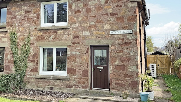 A stone house with a sign reading "WYVIS TERRACE". - Seasgair is a cosy property located in Dingwall, close to all local amenities. (Dingwall)
