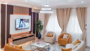 Family Apartment, Balcony, City View | Living area | Flat-screen TV