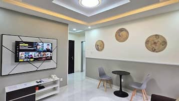 Family Apartment, Balcony, City View | Living area | Flat-screen TV