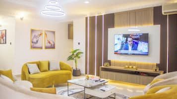 Family Apartment, Balcony, City View | Living area | Flat-screen TV