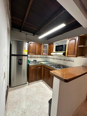 Fridge, microwave, cookware/dishes/utensils