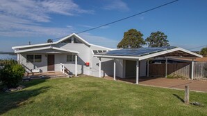 A single-story house with a covered garage and solar panels on the roof.