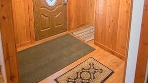 A wooden interior with a door, a small rug, and a staircase. - 10acre Serene Retreat W/ ⭐️⭐️⭐️⭐️⭐️Private Chef Availability!!  (Mars)