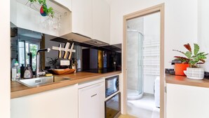 A modern kitchen with a dishwasher, a sink, and a window.