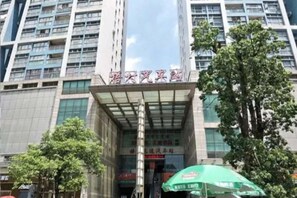 A hotel entrance with a modern facade, large windows, and a prominent entrance canopy. - Super 8 Hotel Premier (Xiamen Railway Station) (Xiamen)