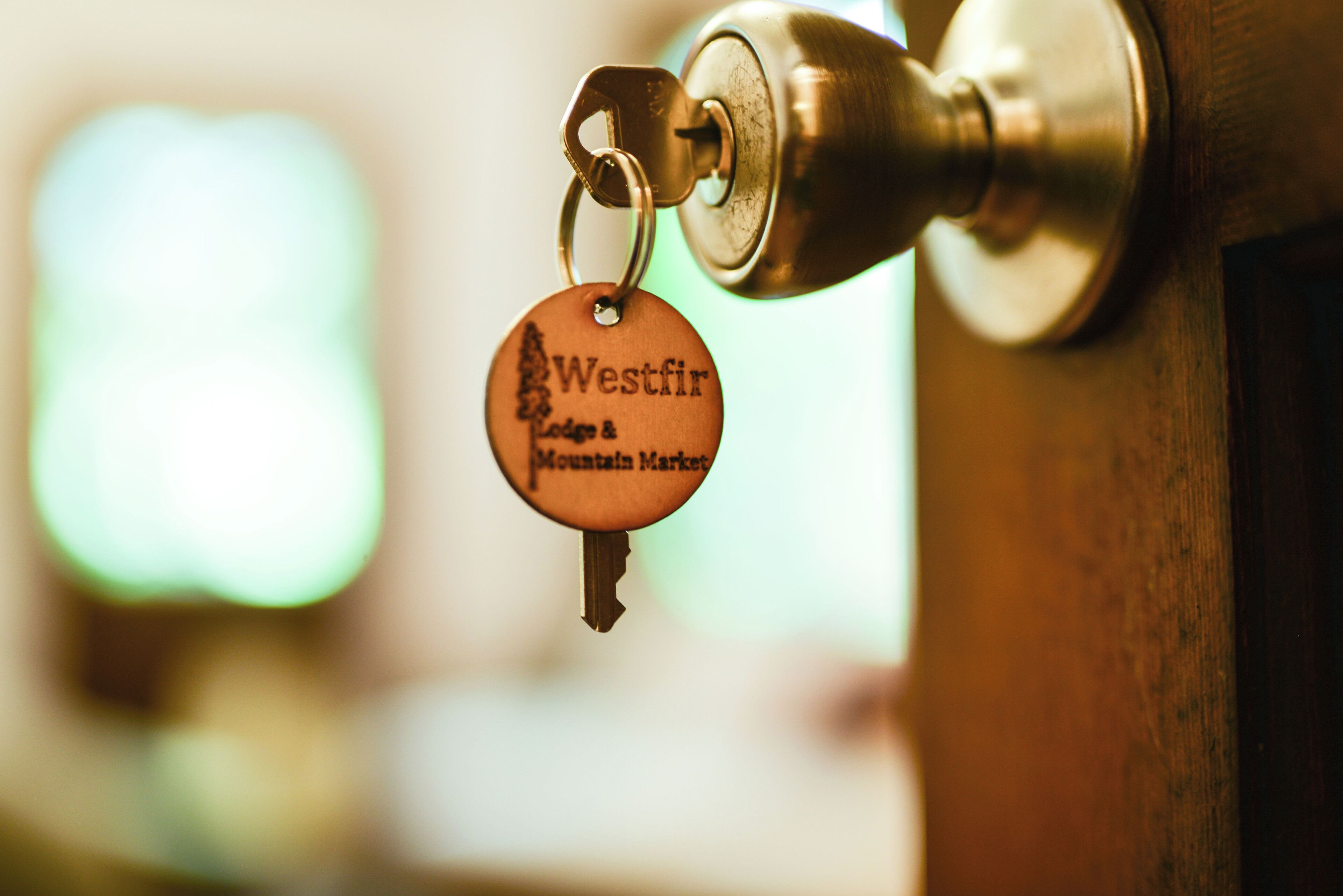A key with a tag attached to a door lock.