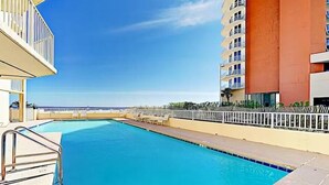 A swimming pool with a view of the ocean, surrounded by buildings. - Beach Front 3BR Condo | Gorgeous Views | Whaler 2D (Gulf Shores)