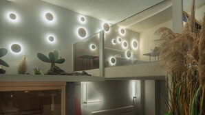 A modern hotel room with a bunk bed, a small desk, and a mirror. - zen escape (San Gregorio di Catania)