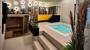 A modern interior with a pool, a staircase, and a seating area with plants. - zen escape (San Gregorio di Catania)