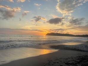 A beach with waves, a sunset, and a distant landmass. - Keep it simple at this peaceful and centrally-located, 2 blocks from the beach (Guanacaste Province)