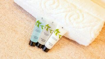 Three Mason & Miller hair care products on a textured beige surface.