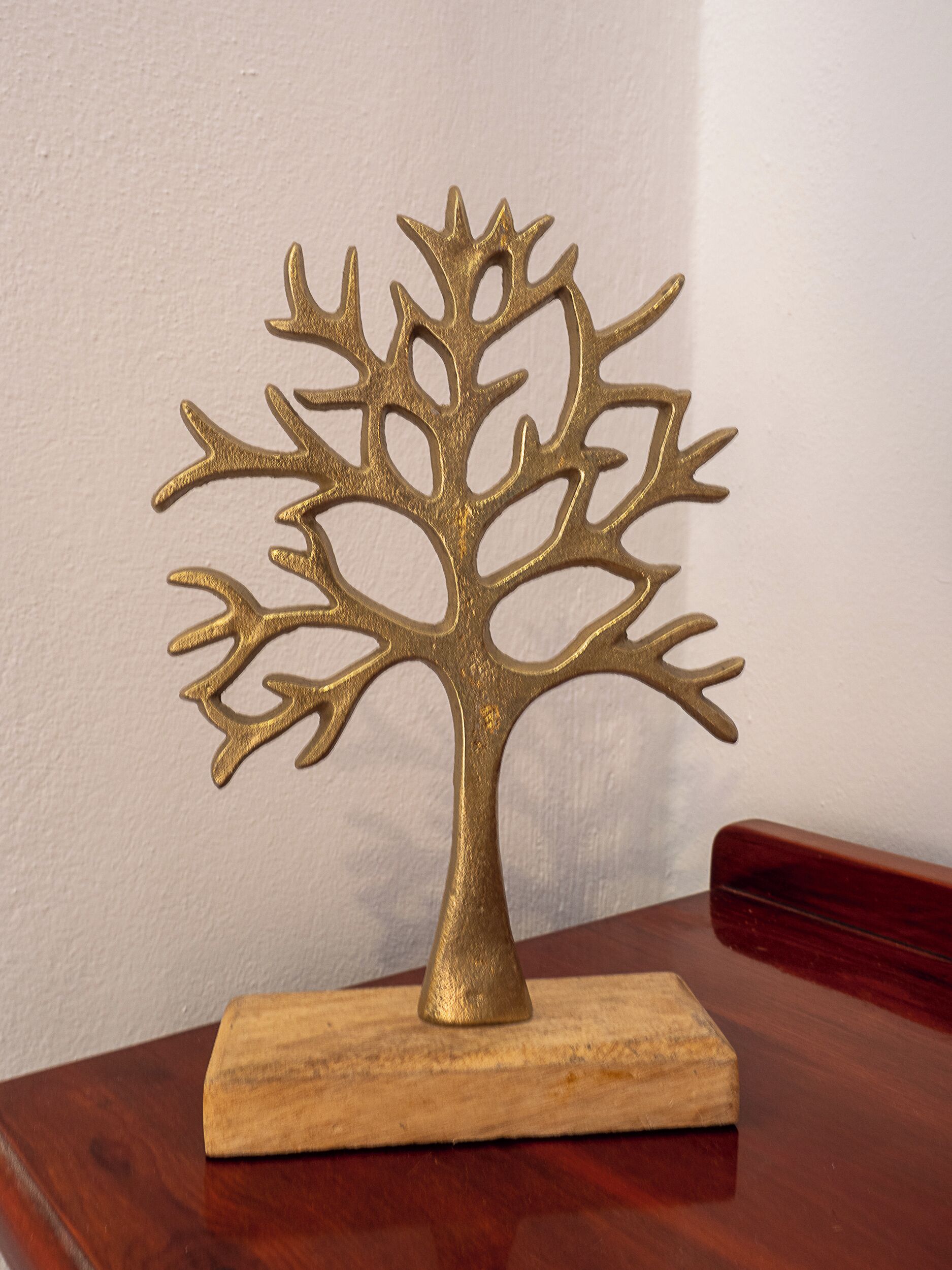 A decorative tree sculpture on a wooden base.