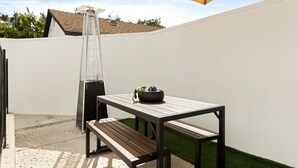 A patio with a table, bench, and grill. - Prestine Pet Friendly Home near Ontario Airport- Convection Center  (Ontario)