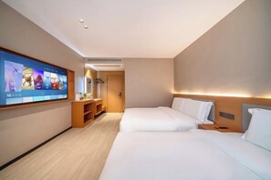 A hotel room with two beds, a TV on the wall, a wooden cabinet, and a door leading to a bathroom. - 99 Xinyi Hotel (Shanghai Jiuxin Highway Shop) (Shanghai)