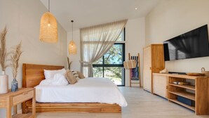 Un dormitorio moderno con una cama de madera, un televisor y un amplio ventanal con cortinas.