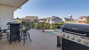 A deck with a grill and outdoor seating. - Pool, Theater & Gym: Spacious Home in Bel Aire (Bel Aire)